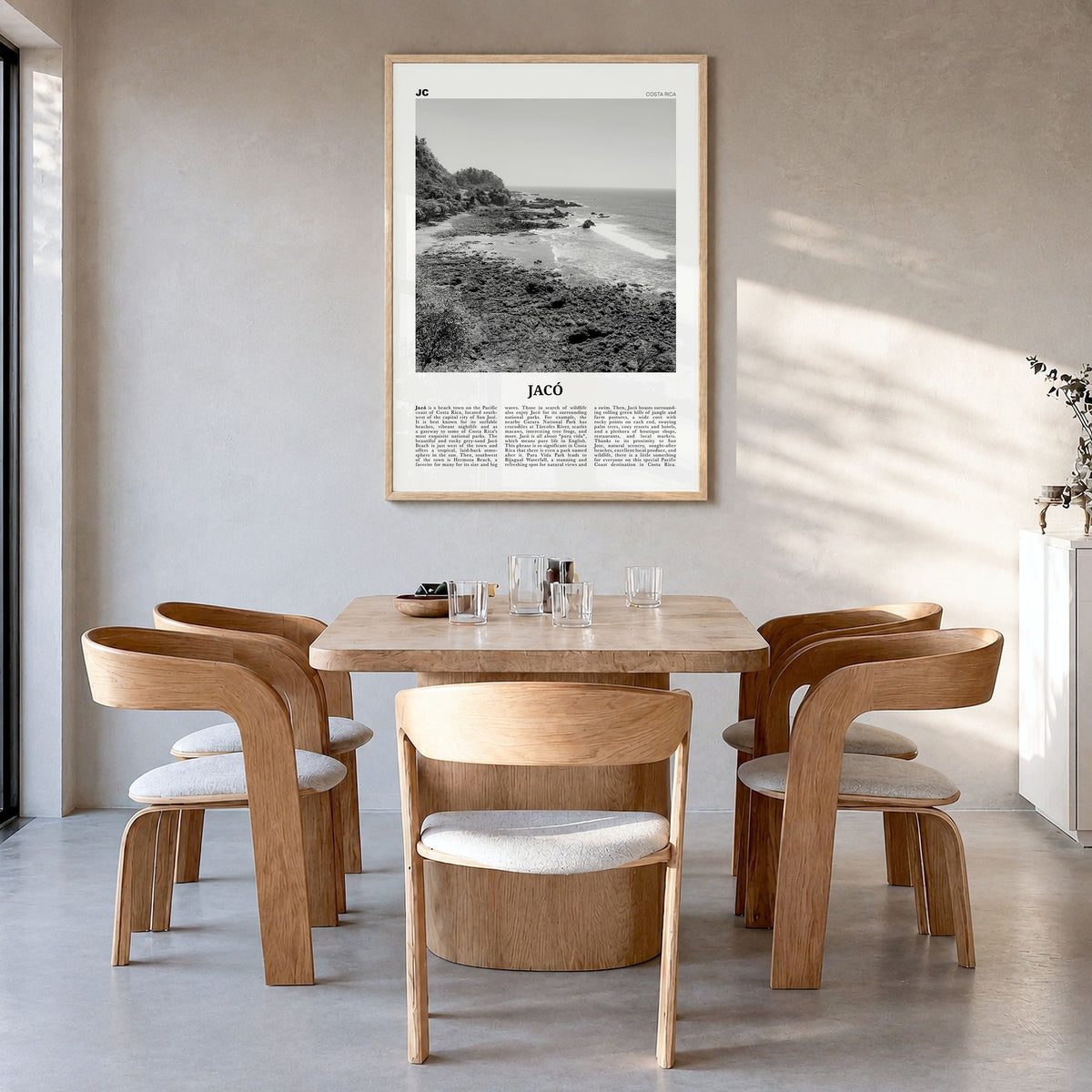 Jacó Newspaper Poster in a natural wood frame, hanging in a dining room