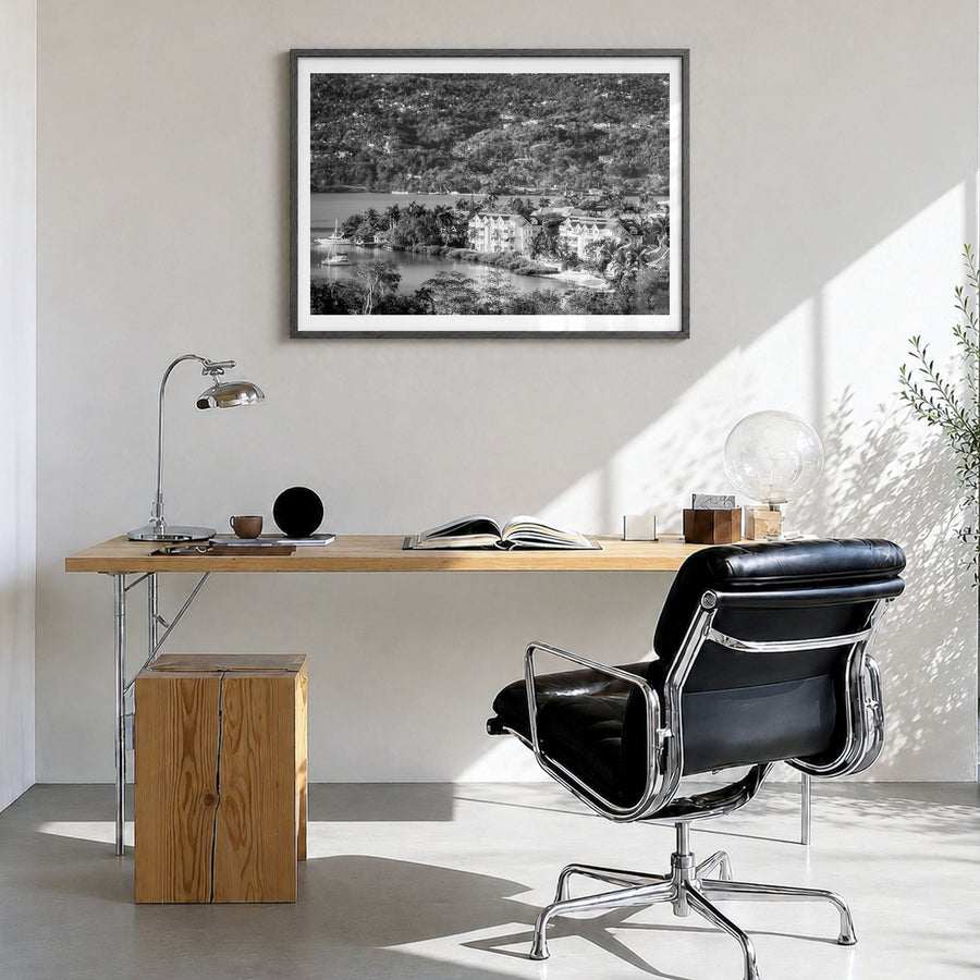 Jamaica Photo Poster in a black wood frame, hanging in a bright home office, white border