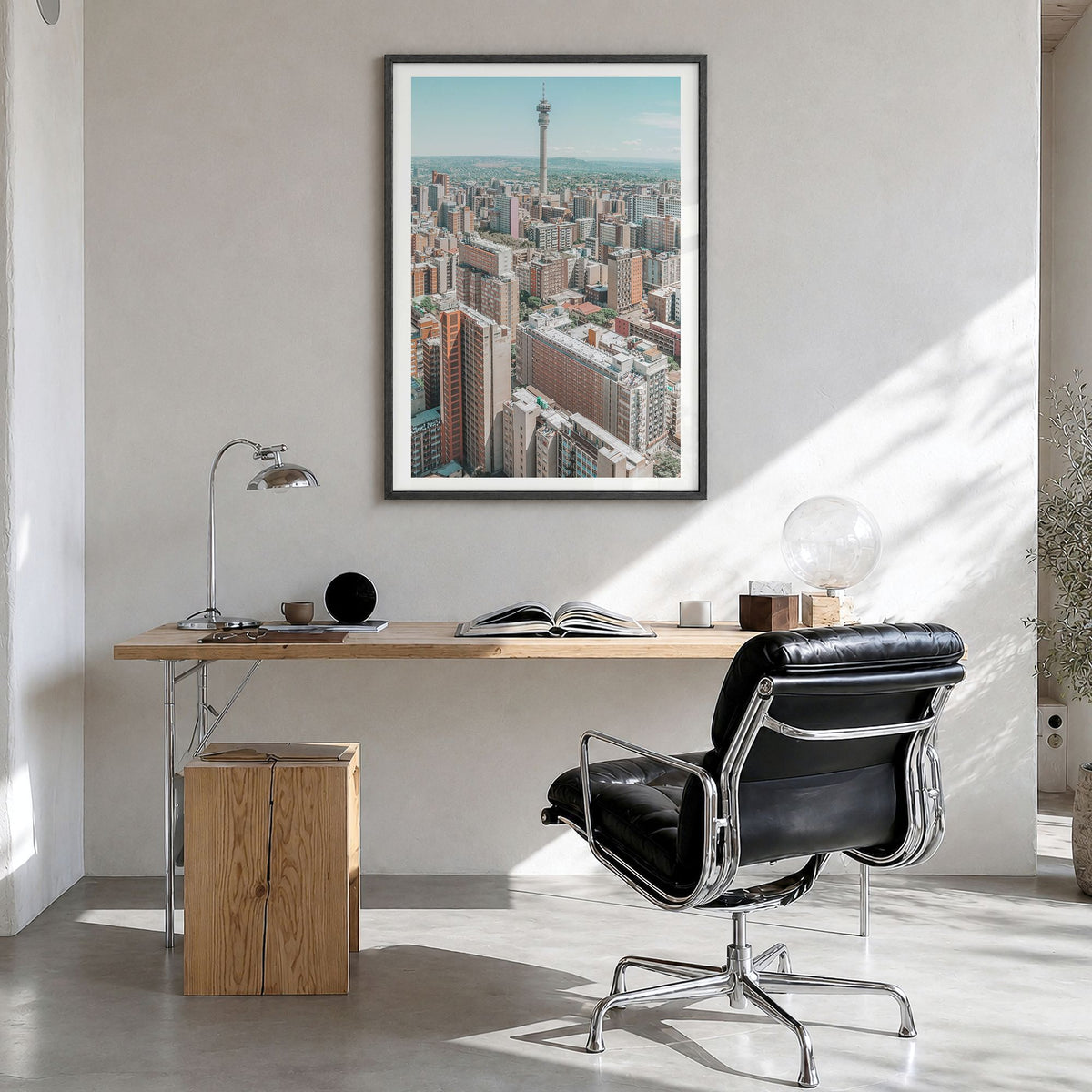 Johannesburg Photo Poster in a black wood frame, hanging in a bright home office, white border