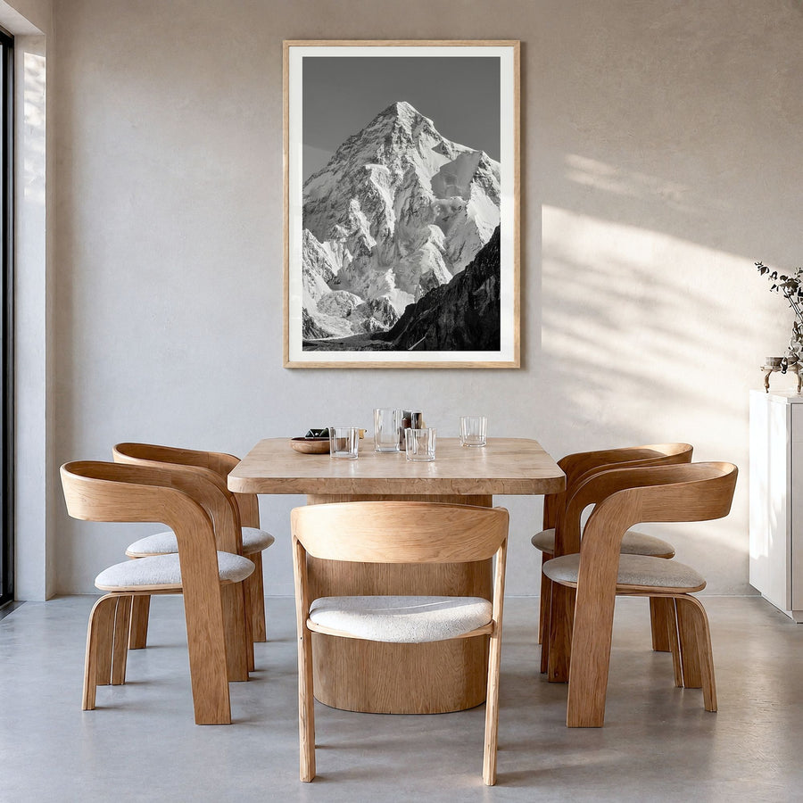 K2 Photo Poster in a natural wood frame, hanging in a dining room, white border