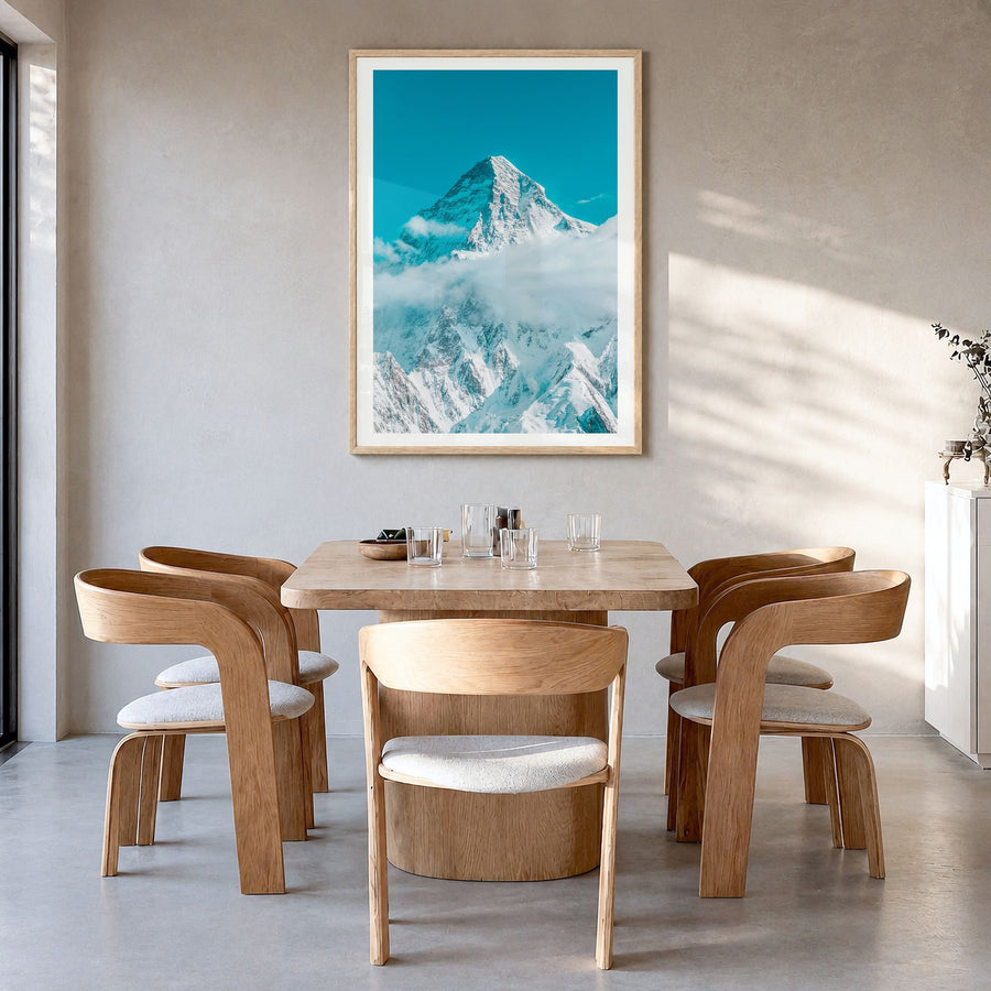 K2 Photo Poster in a natural wood frame, hanging in a dining room, white border
