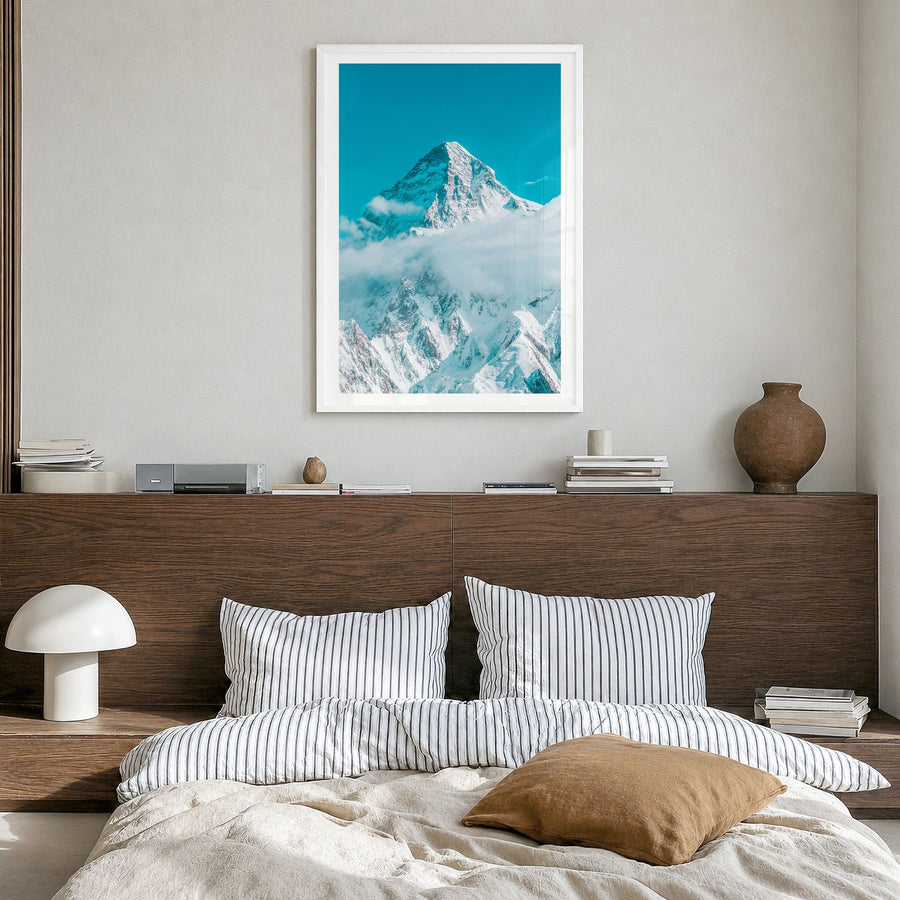 K2 Photo Poster in a white wood frame, hanging in a bedroom, white border