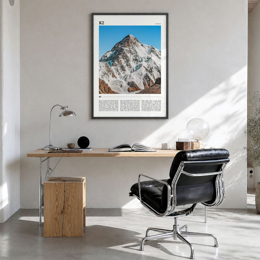 K2 Travel Poster in a black wood frame, hanging in a bright home office