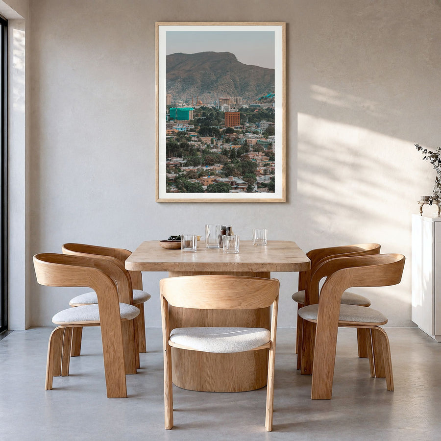 Kabul Photo Poster in a natural wood frame, hanging in a dining room, white border