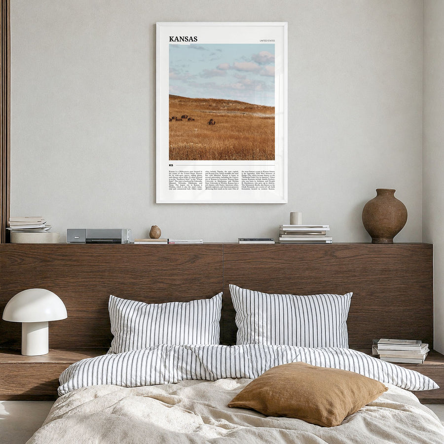 Kansas Travel Poster in a white wood frame, hanging in a bedroom