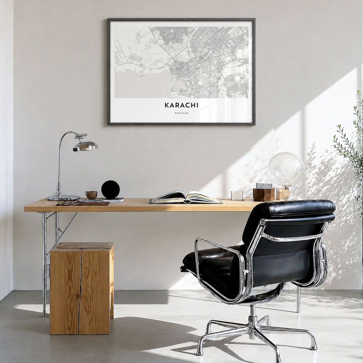 Karachi Map Poster in a black wood frame, hanging in a bright home office
