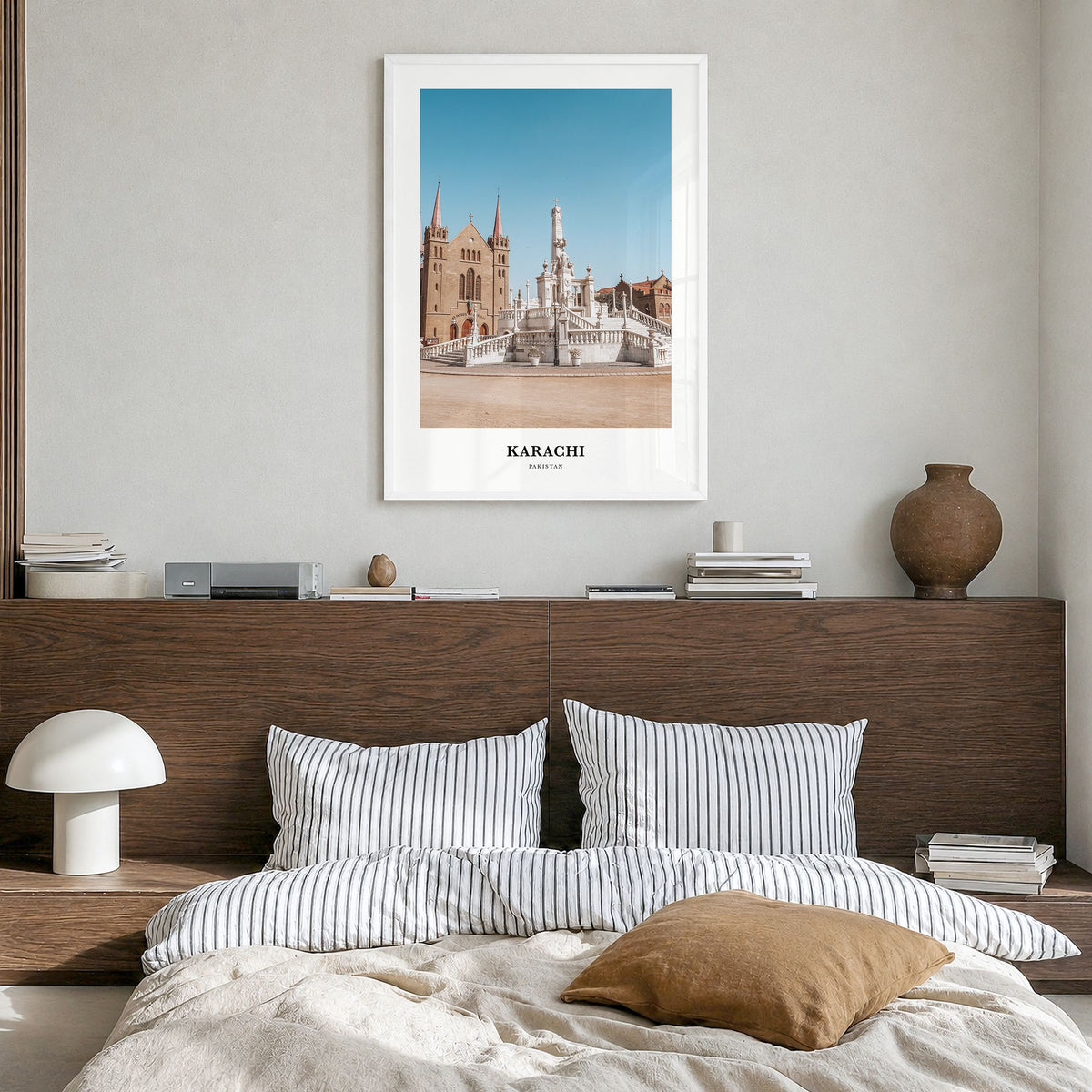 Karachi Classic No 1 Poster in a white wood frame, hanging in a bedroom