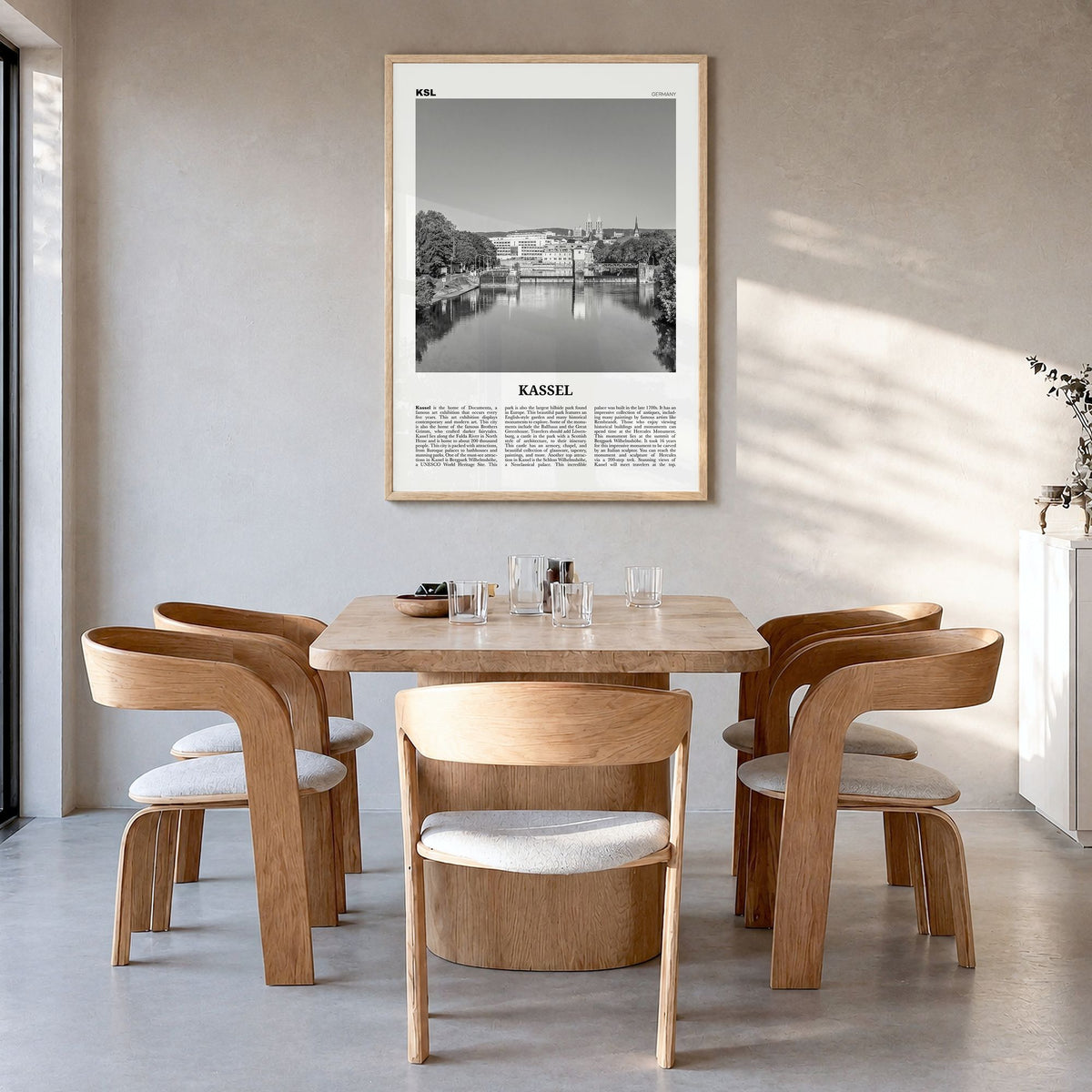 Kassel Newspaper Poster in a natural wood frame, hanging in a dining room