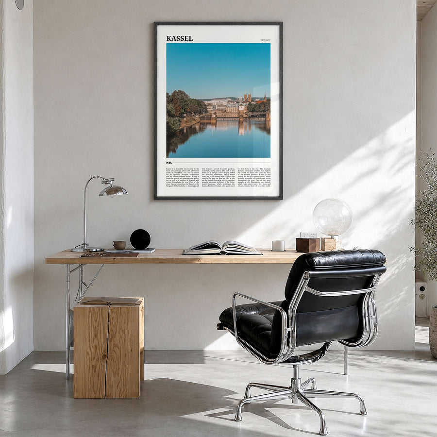 Kassel Travel Poster in a black wood frame, hanging in a bright home office