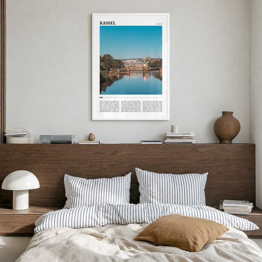 Kassel Travel Poster in a white wood frame, hanging in a bedroom