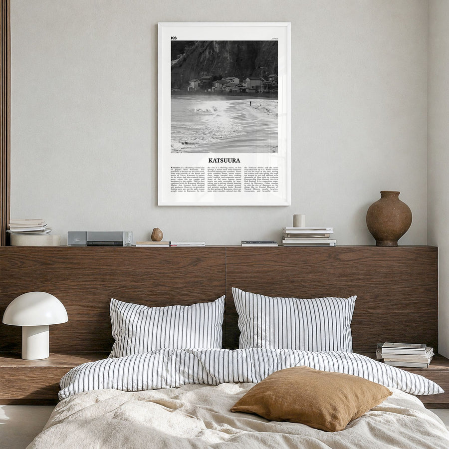 Katsuura Newspaper Poster in a white wood frame, hanging in a bedroom