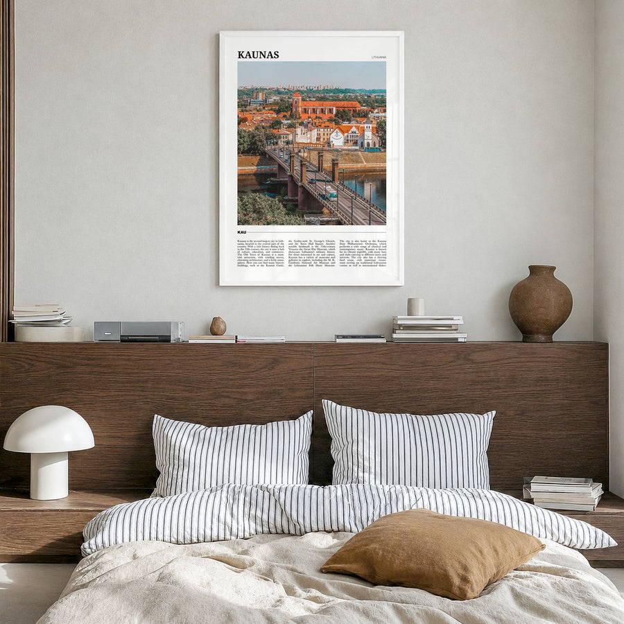 Kaunas Travel Poster in a white wood frame, hanging in a bedroom