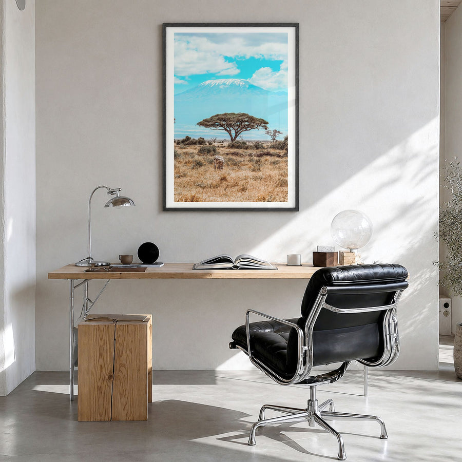 Kenya Photo Poster in a black wood frame, hanging in a bright home office, white border