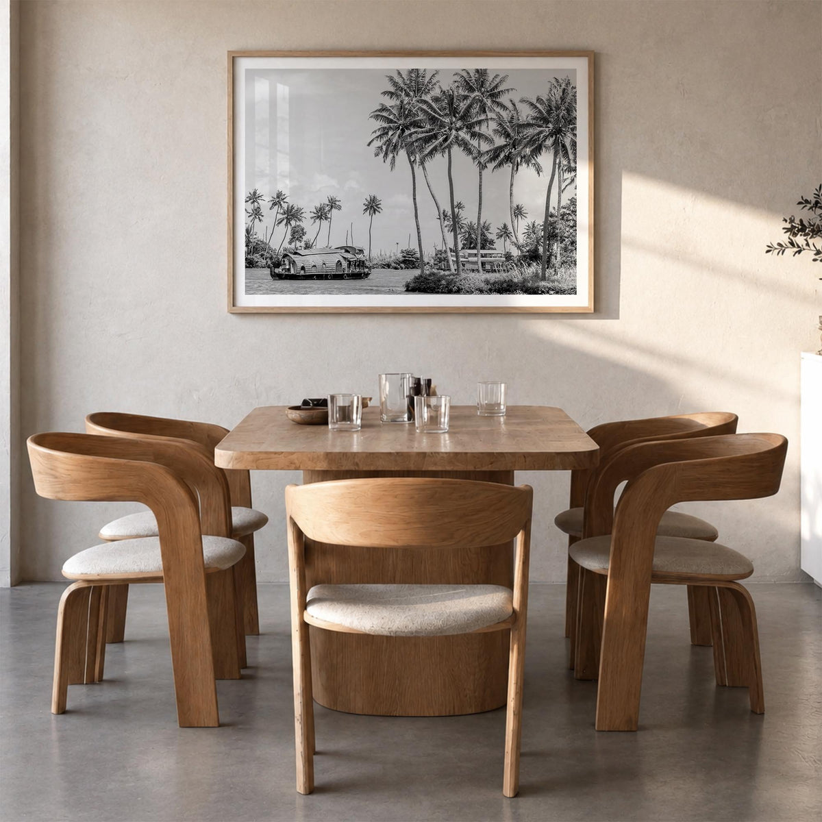 Kerala black & white photo poster of India – horizontal wall art in natural wood frame with white border, hanging on wall