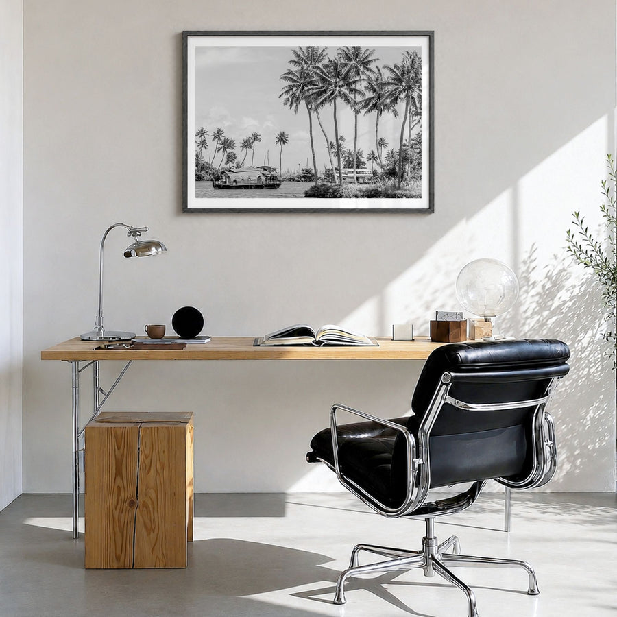 Kerala Photo Poster in a black wood frame, hanging in a bright home office, white border
