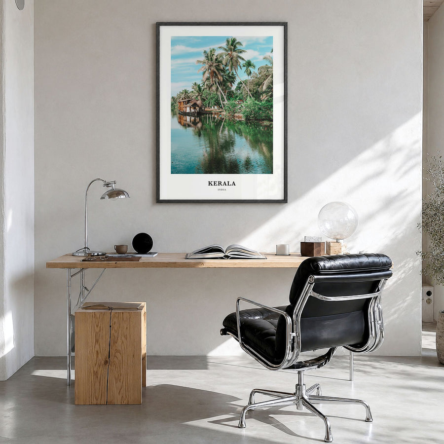 Kerala Classic Poster in a black wood frame, hanging in a bright home office