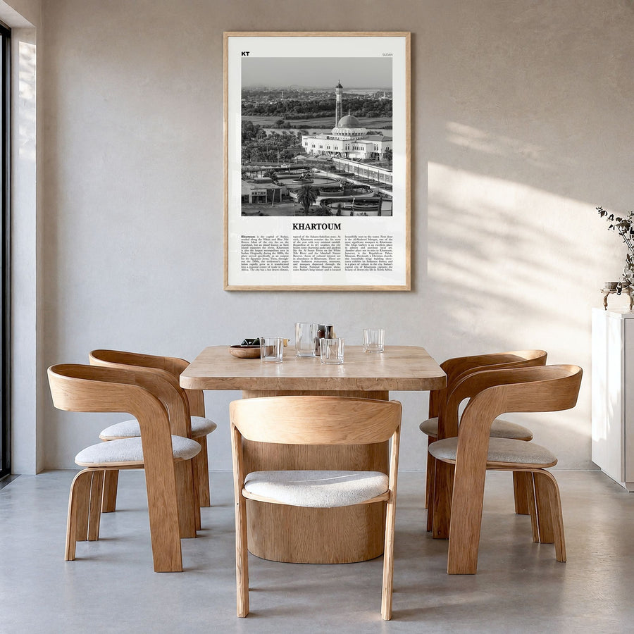 Khartoum Newspaper Poster in a natural wood frame, hanging in a dining room