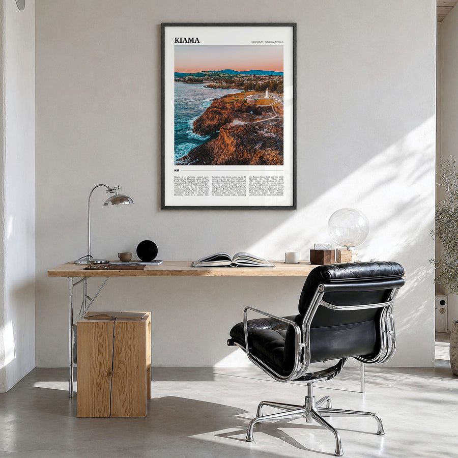 Kiama Travel Poster in a black wood frame, hanging in a bright home office