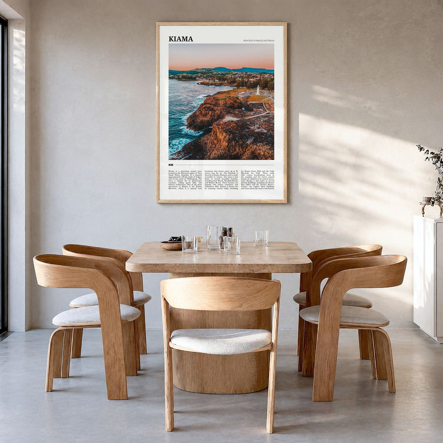 Kiama Travel Poster in a natural wood frame, hanging in a dining room