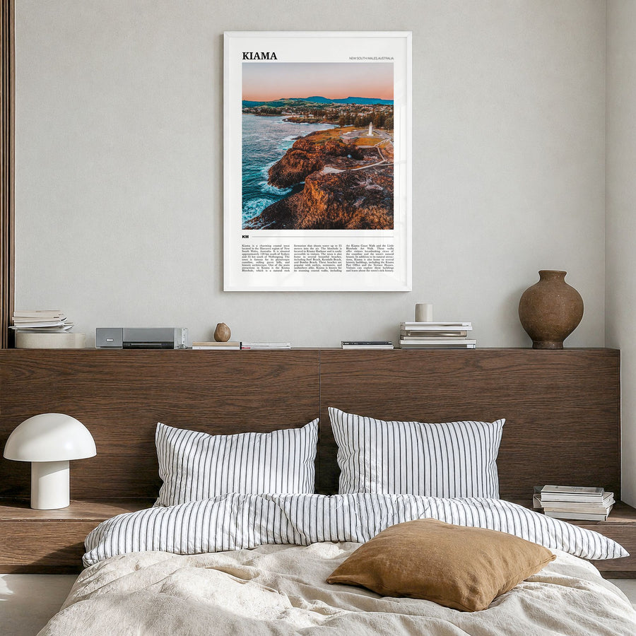Kiama Travel Poster in a white wood frame, hanging in a bedroom