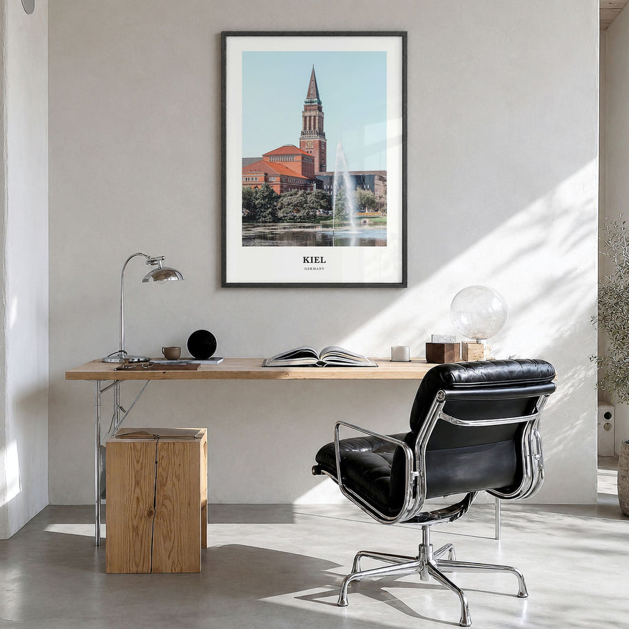 Kiel Classic Poster in a black wood frame, hanging in a bright home office