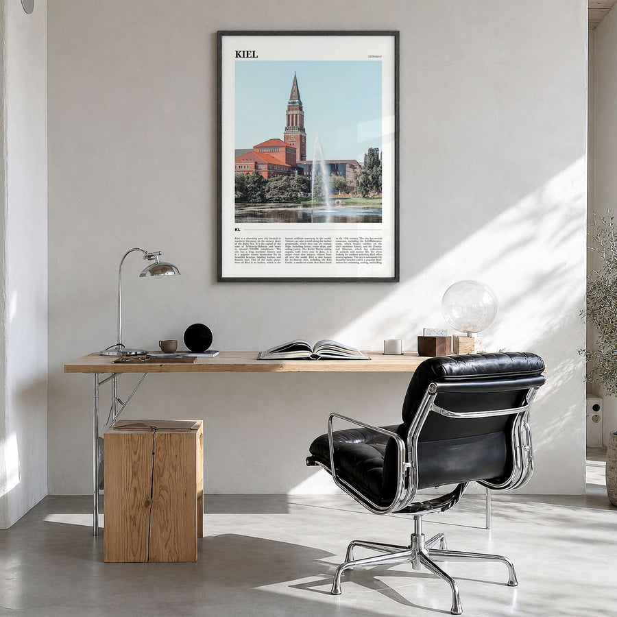 Kiel Travel Poster in a black wood frame, hanging in a bright home office