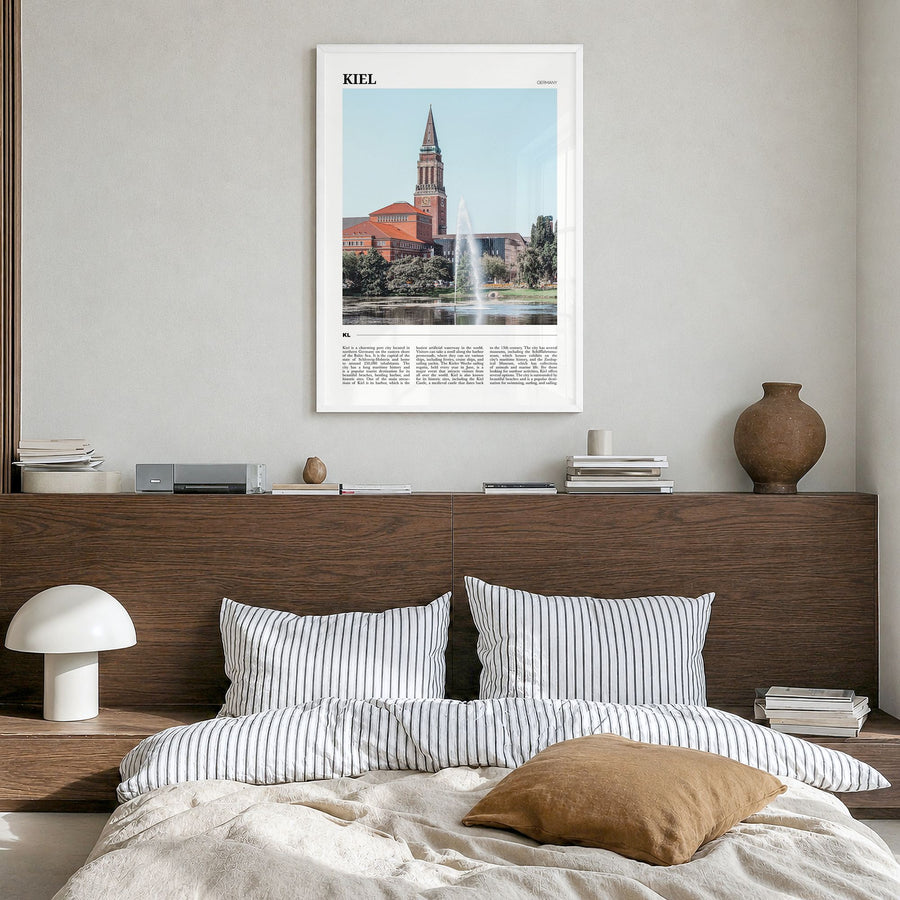 Kiel Travel Poster in a white wood frame, hanging in a bedroom