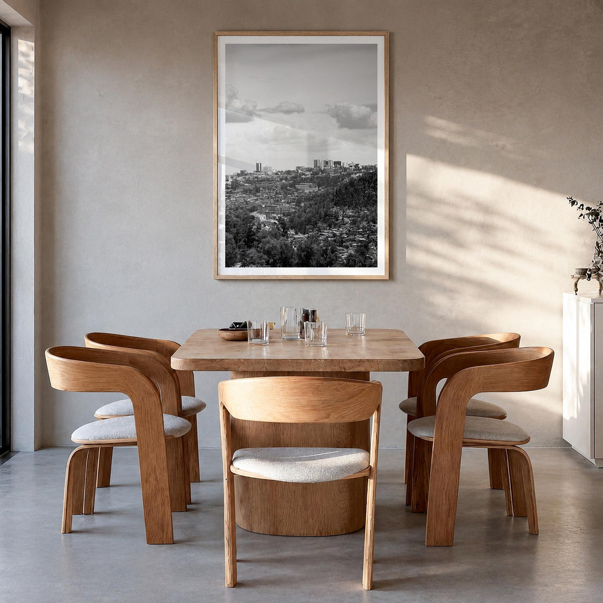 Kigali black & white photo poster of Rwanda – vertical wall art in natural wood frame with white border, hanging on wall