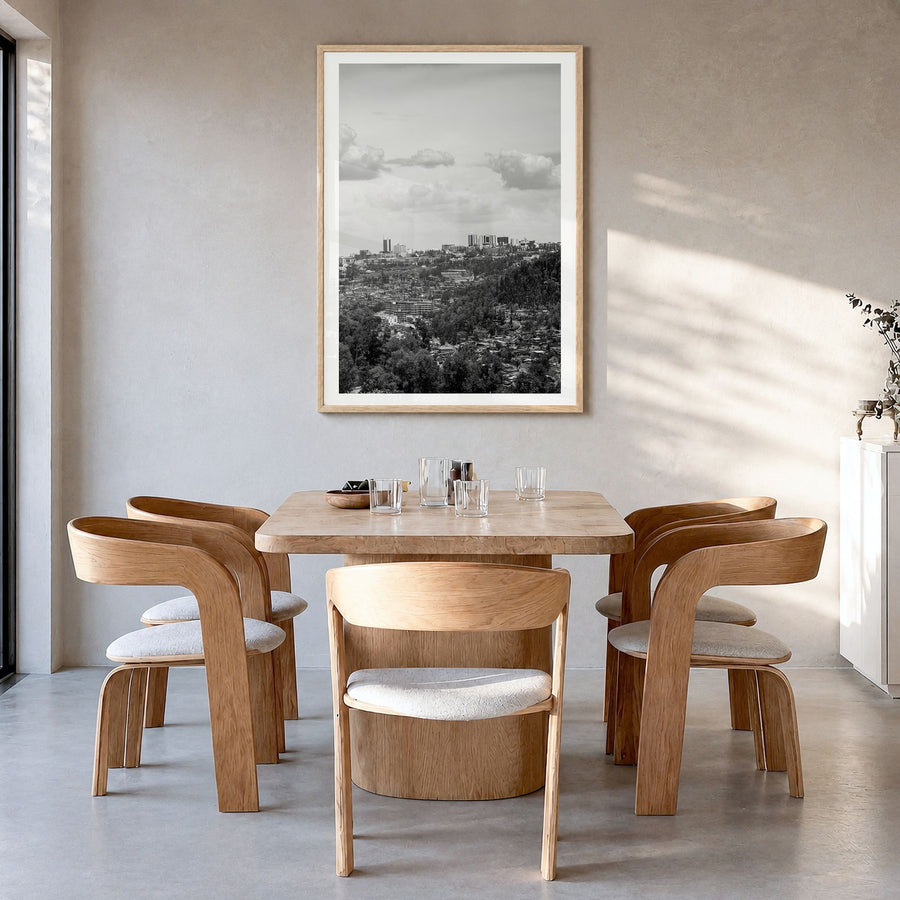 Kigali Photo Poster in a natural wood frame, hanging in a dining room, white border