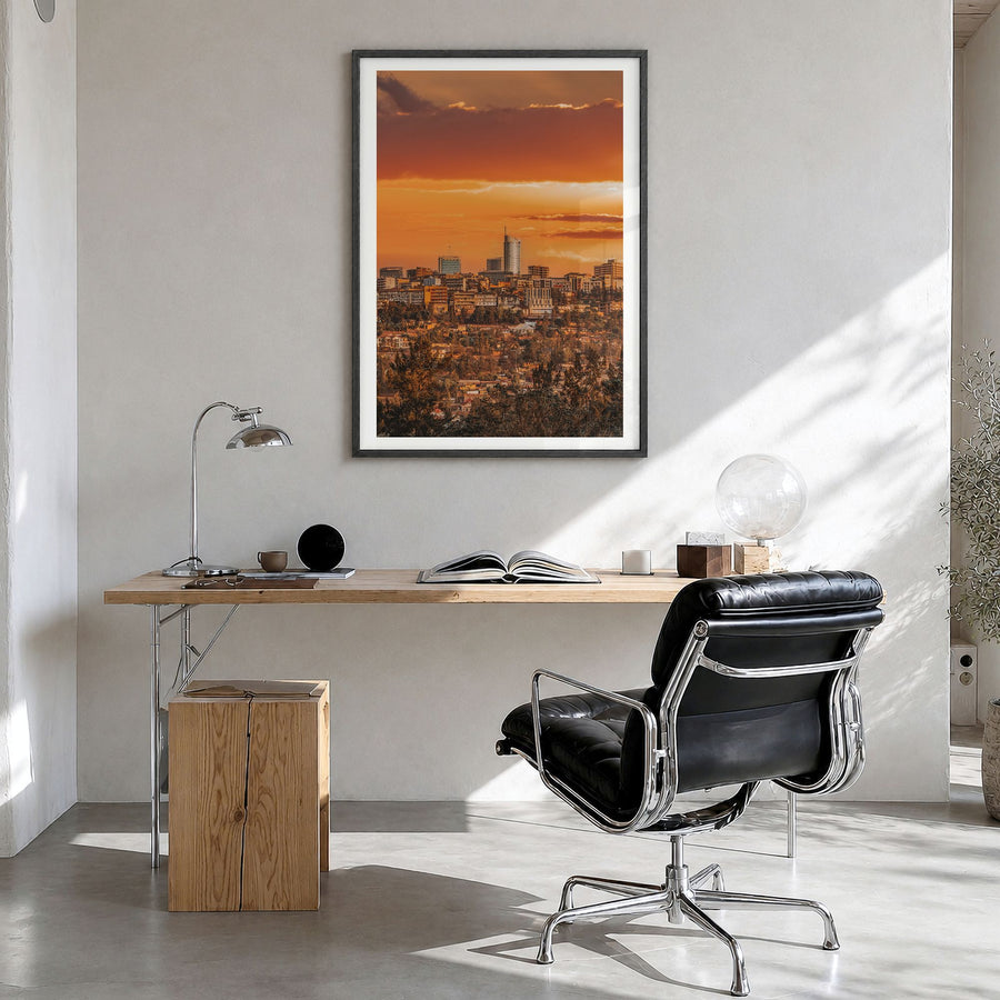Kigali Photo Poster in a black wood frame, hanging in a bright home office, white border