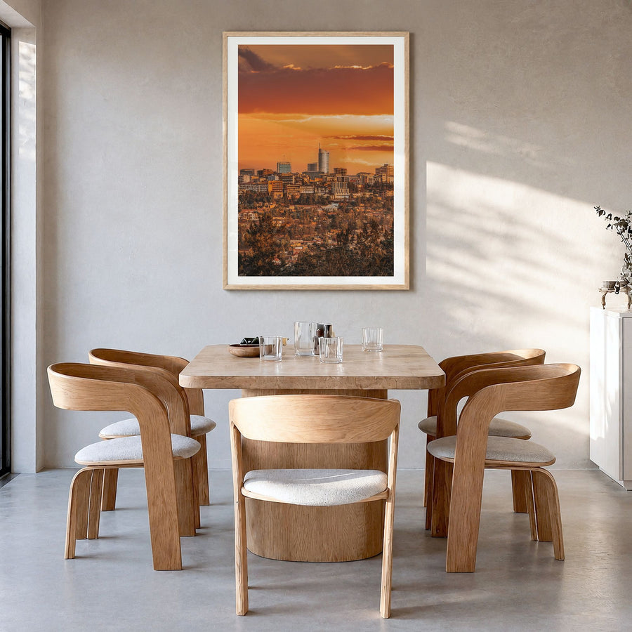 Kigali Photo Poster in a natural wood frame, hanging in a dining room, white border