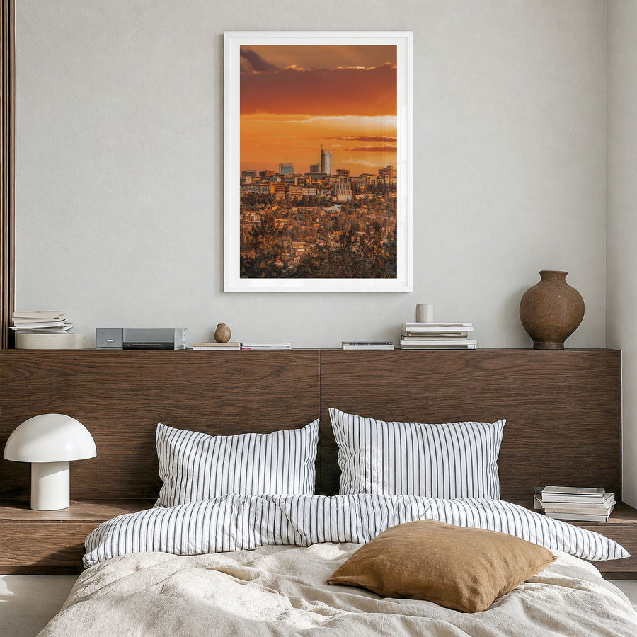 Kigali Photo Poster in a white wood frame, hanging in a bedroom, white border