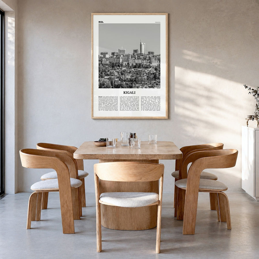 Kigali Newspaper Poster in a natural wood frame, hanging in a dining room