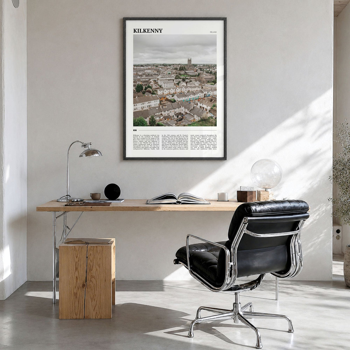 Kilkenny Travel Poster in a black wood frame, hanging in a bright home office