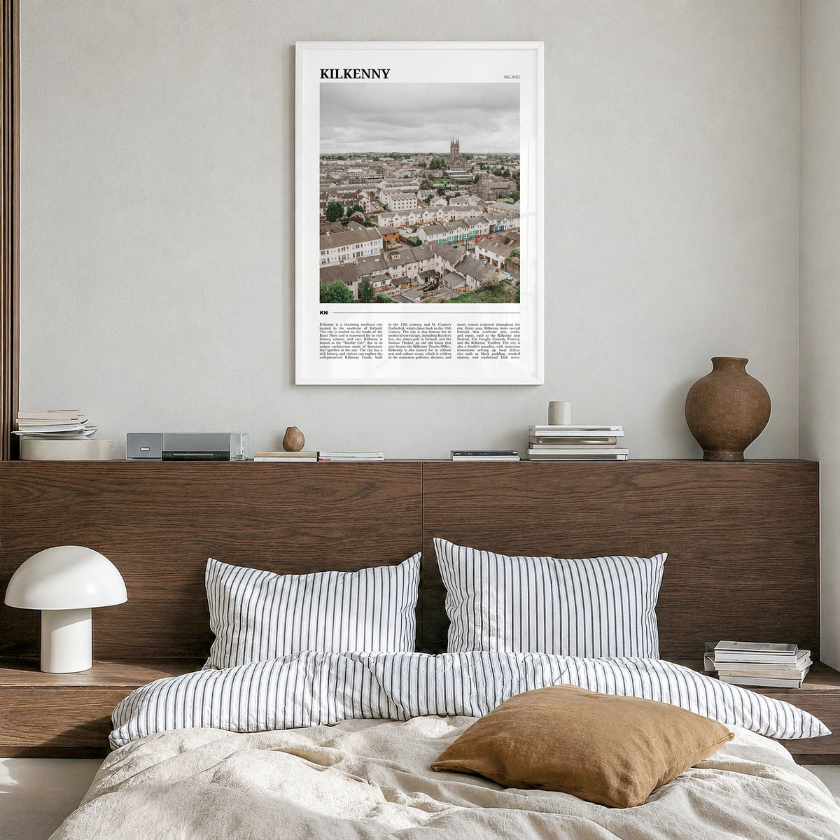 Kilkenny Travel Poster in a white wood frame, hanging in a bedroom