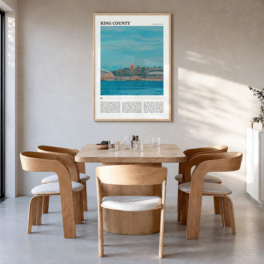 King County Travel Poster in a natural wood frame, hanging in a dining room