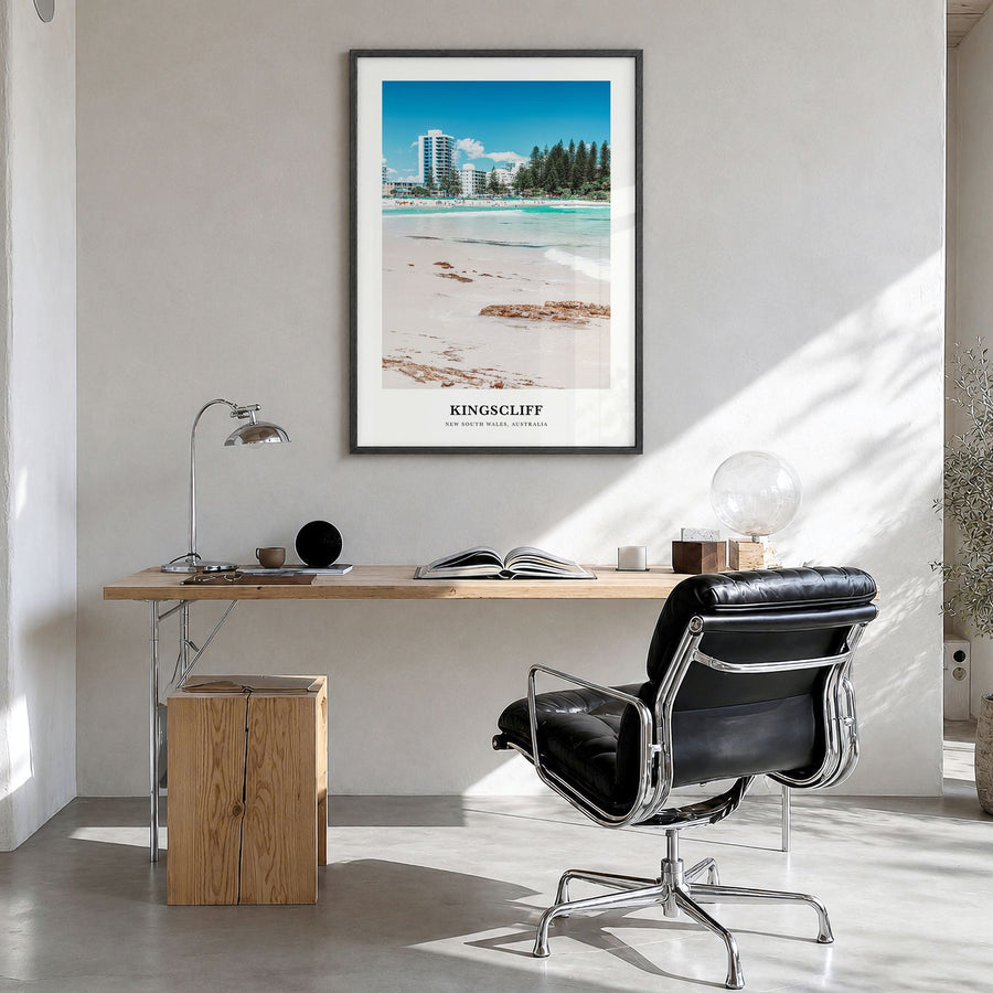 Kingscliff Classic Poster in a black wood frame, hanging in a bright home office