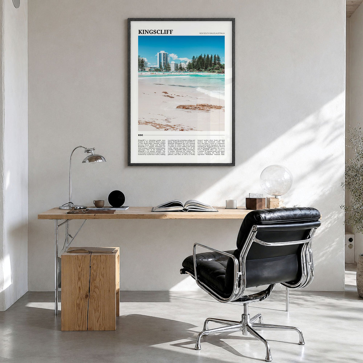 Kingscliff Travel Poster in a black wood frame, hanging in a bright home office