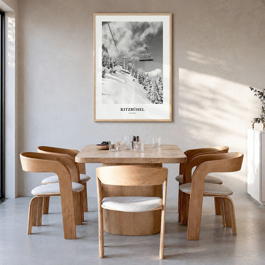 Kitzbühel Classic Poster in a natural wood frame, hanging in a dining room