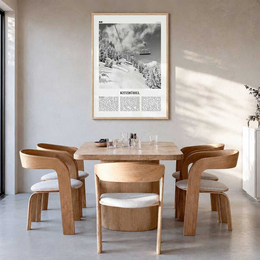 Kitzbühel Newspaper Poster in a natural wood frame, hanging in a dining room