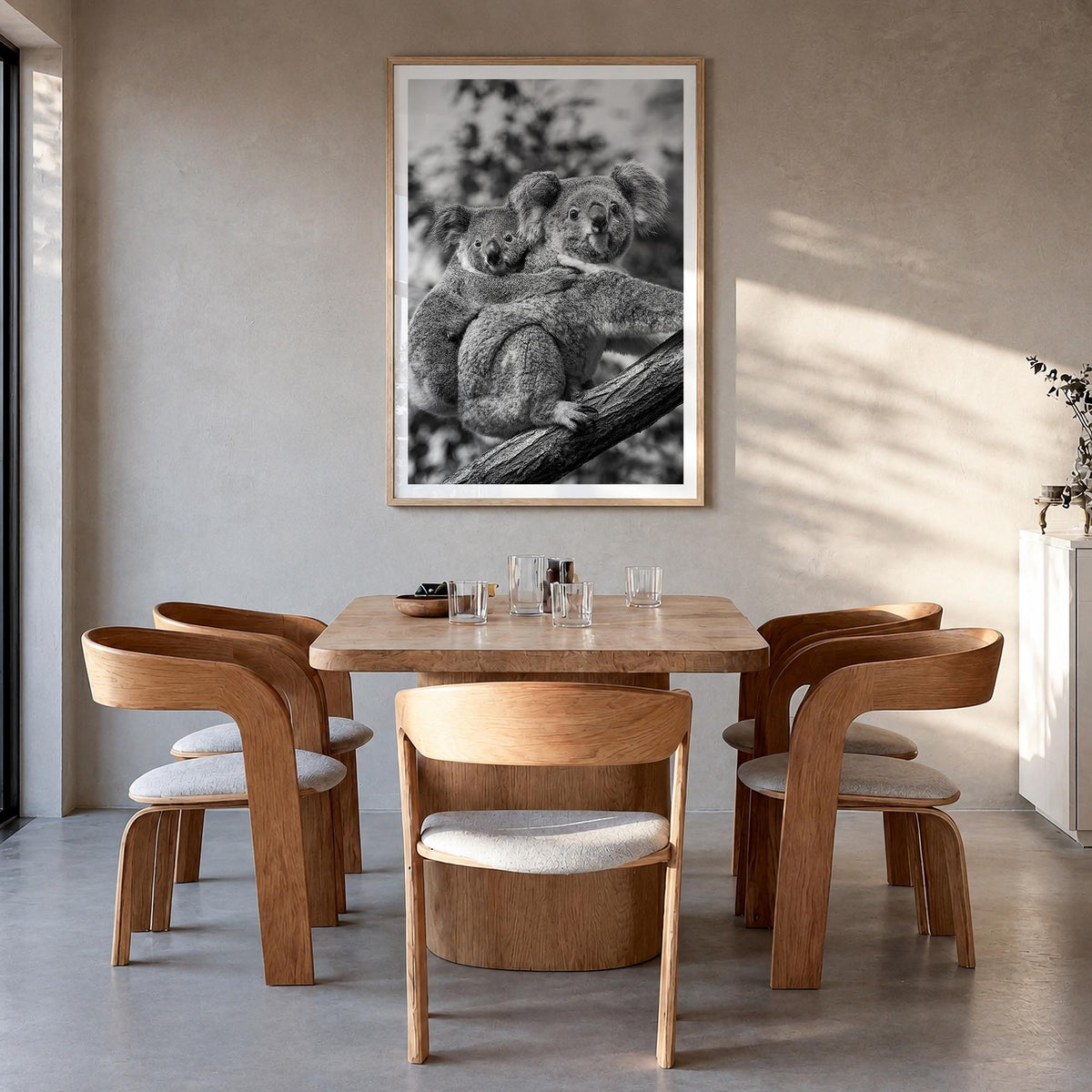 Koala no. 1 black & white photo poster – vertical wall art in natural wood frame with white border, hanging on wall