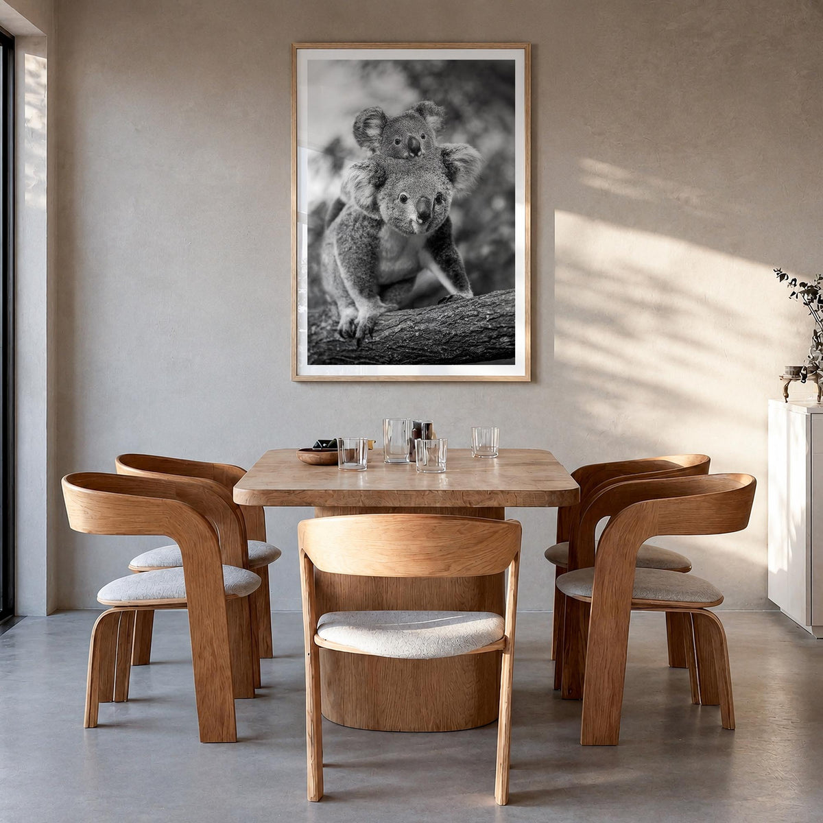 Koala no. 2 black & white photo poster – vertical wall art in natural wood frame with white border, hanging on wall