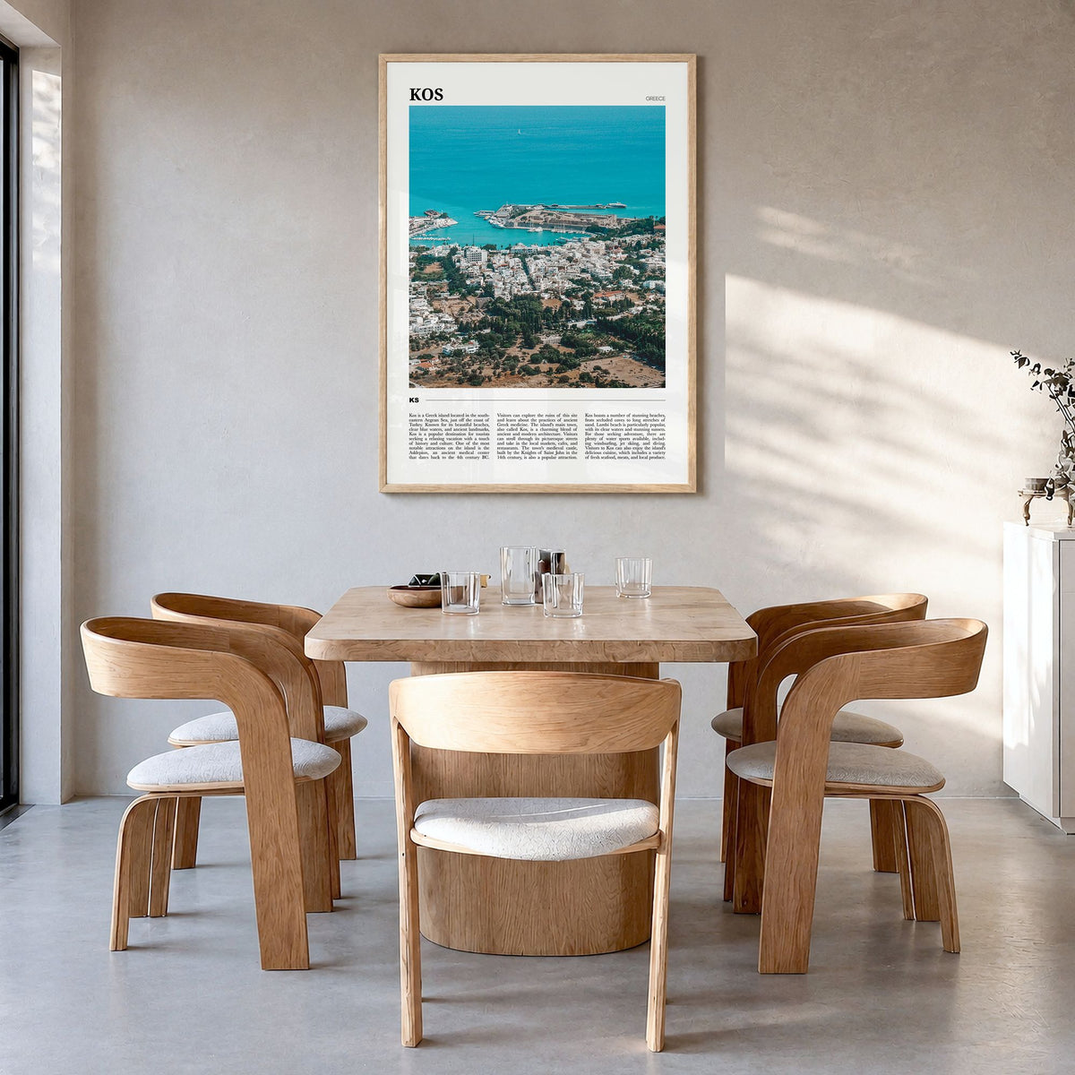 Kos Travel Poster in a natural wood frame, hanging in a dining room