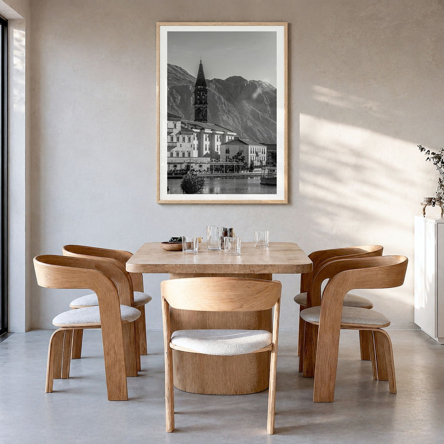 Kotor Photo Poster in a natural wood frame, hanging in a dining room, white border