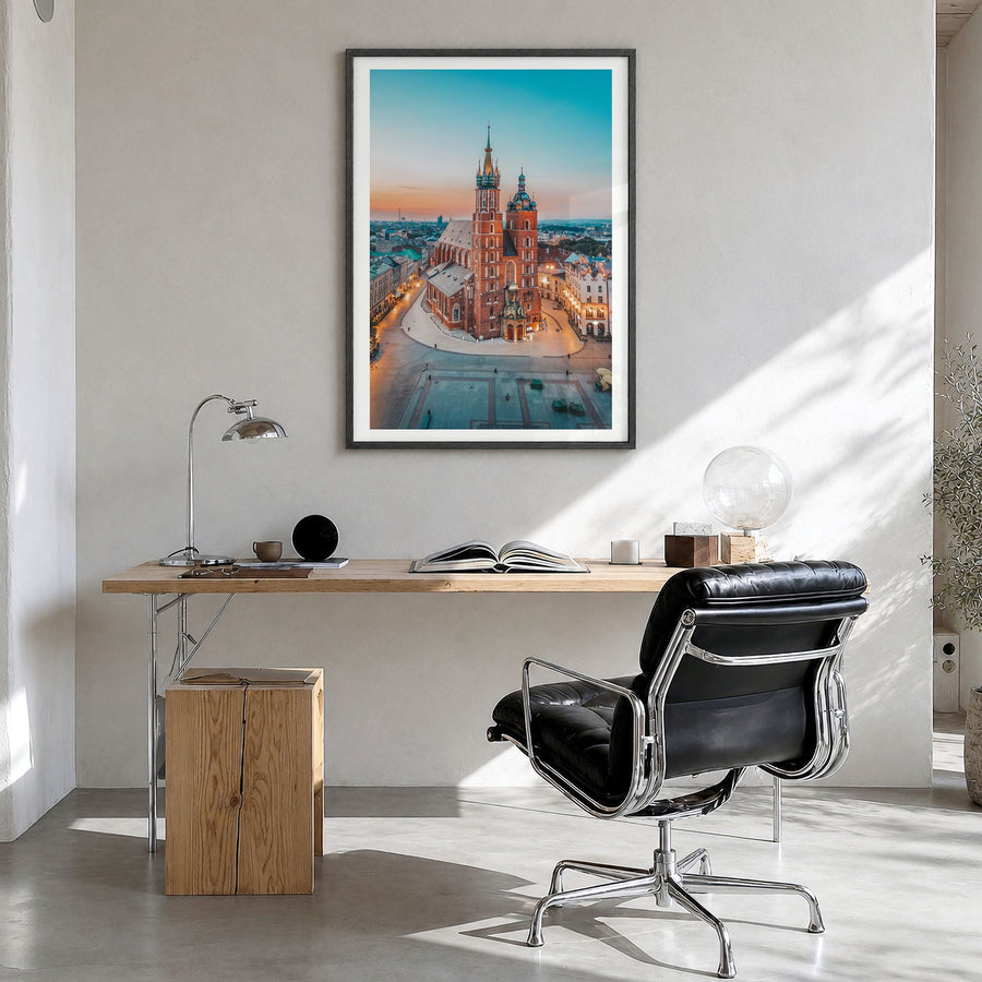Kraków Photo Poster in a black wood frame, hanging in a bright home office, white border