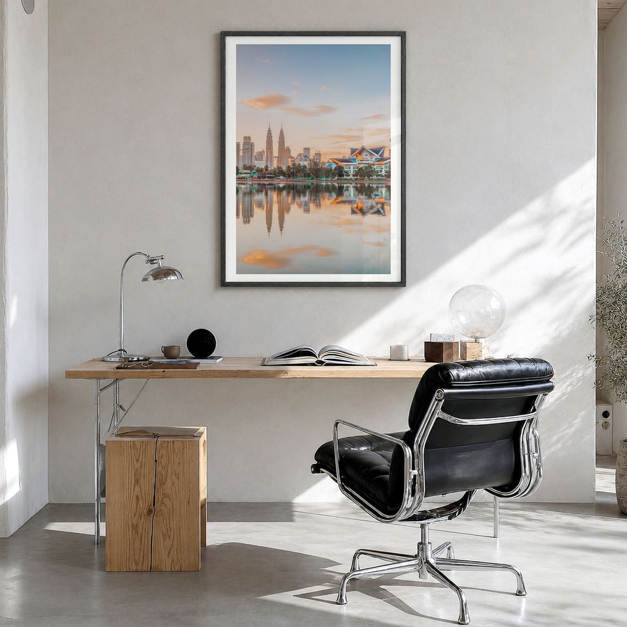 Kuala Lumpur Photo Poster in a black wood frame, hanging in a bright home office, white border