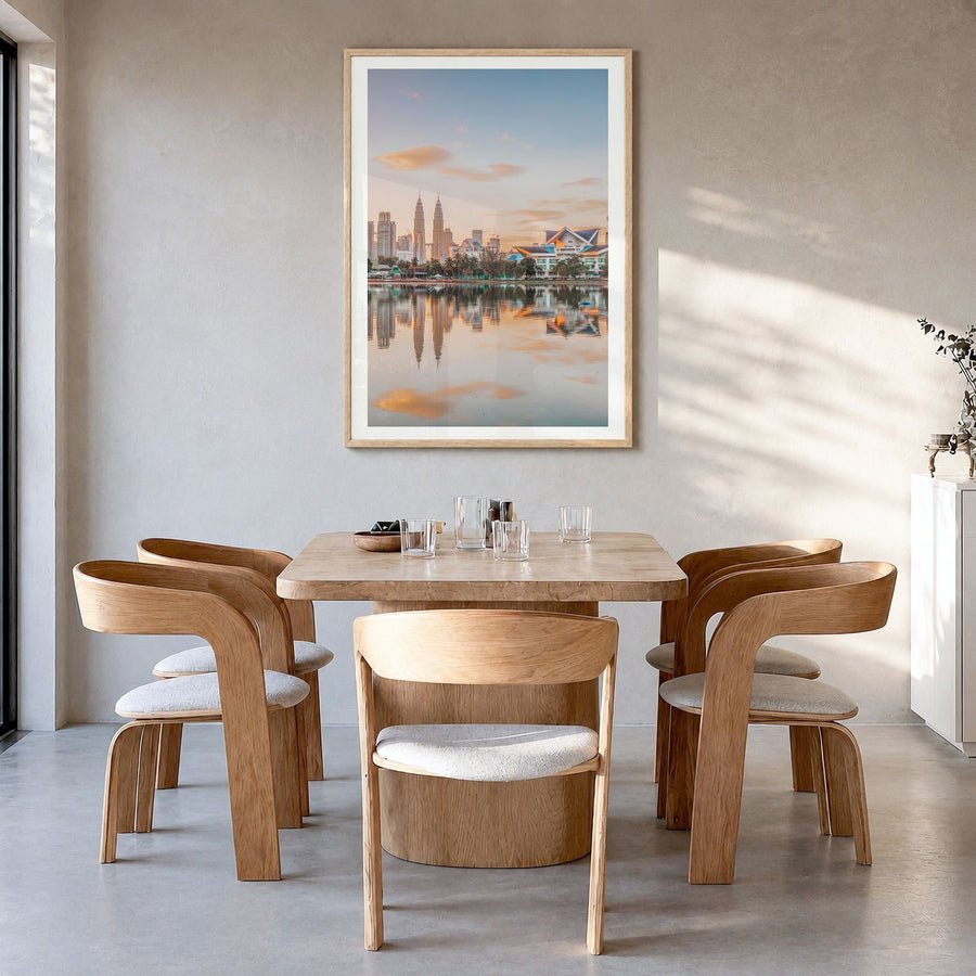 Kuala Lumpur Photo Poster in a natural wood frame, hanging in a dining room, white border