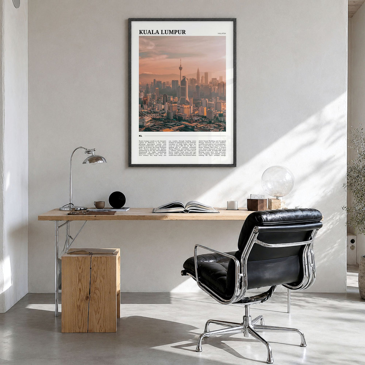 Kuala Lumpur Travel Poster in a black wood frame, hanging in a bright home office