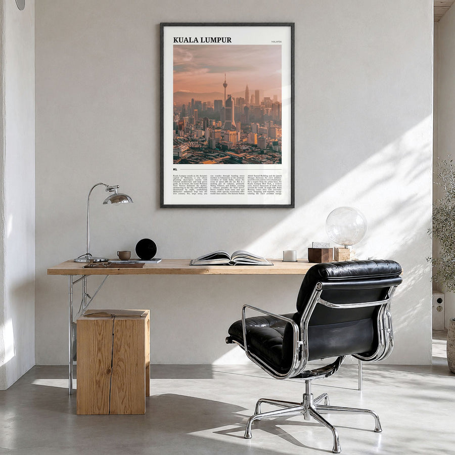Kuala Lumpur Travel Poster in a black wood frame, hanging in a bright home office