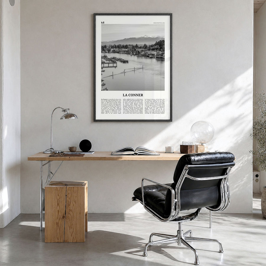 La Conner Newspaper Poster in a black wood frame, hanging in a bright home office